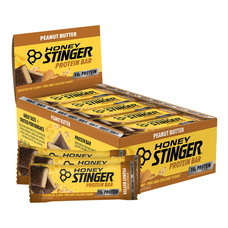 A display box and individual wrapped Honey Stinger Protein Bar in Peanut Butter flavor, shown on a plain white background.