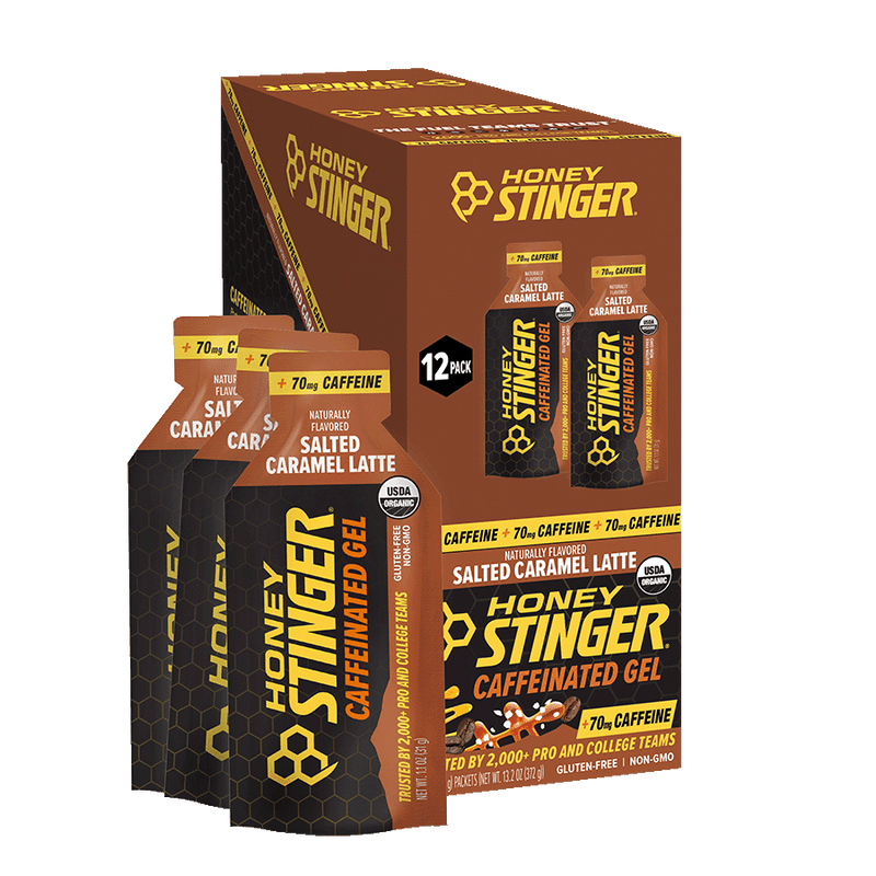 Product box (12-count) and two gel packets of Honey Stinger Salted Caramel Latte Caffeinated Energy Gel on white background, standard main/hero product shot