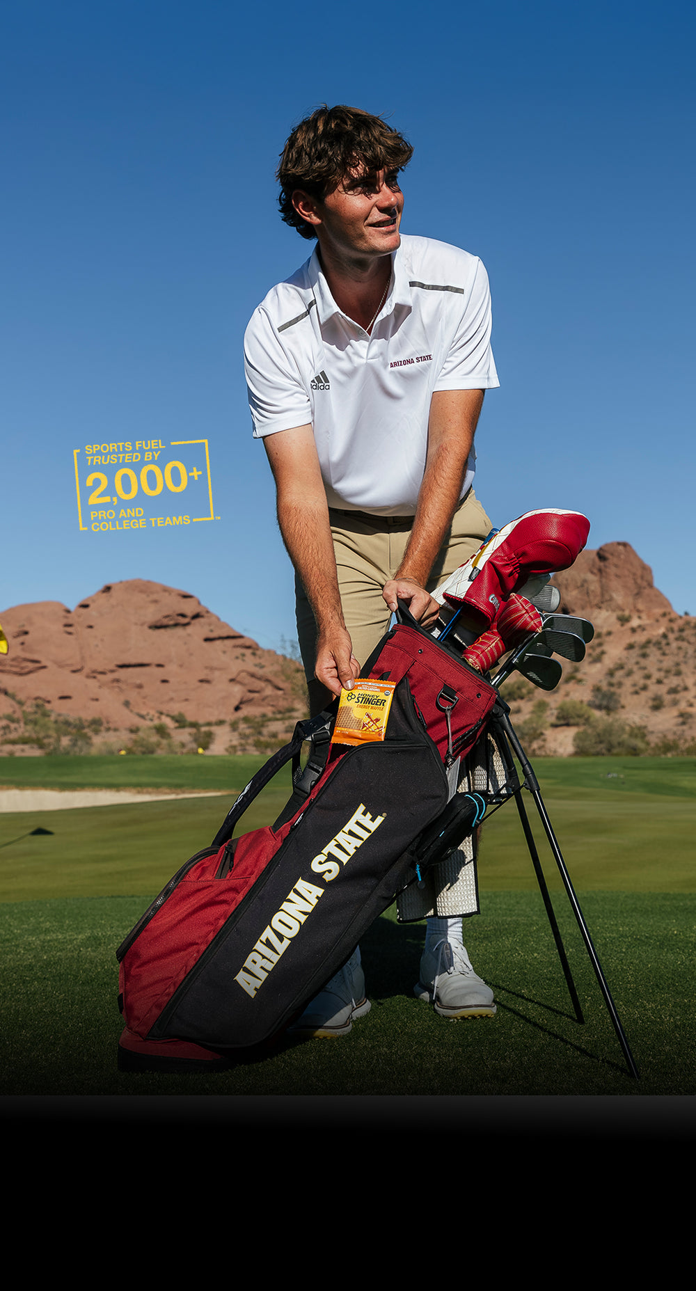 Man holding a golf bag with Arizona State branding on a golf course