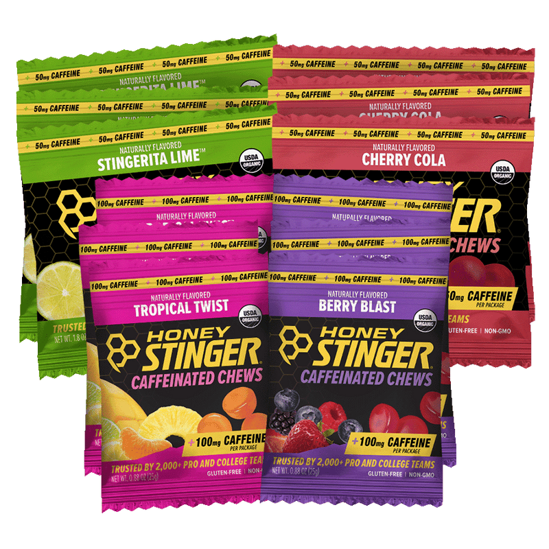 Assorted packages of Honey Stinger caffeinated chews in various flavors on a white background.