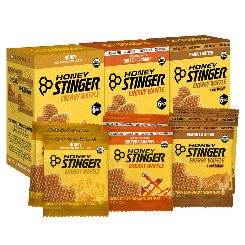 3 Honey Stinger energy waffle packages on a white background