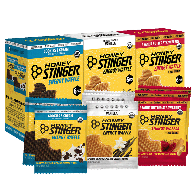 Honey Stinger energy waffle packages in various flavors on a white background