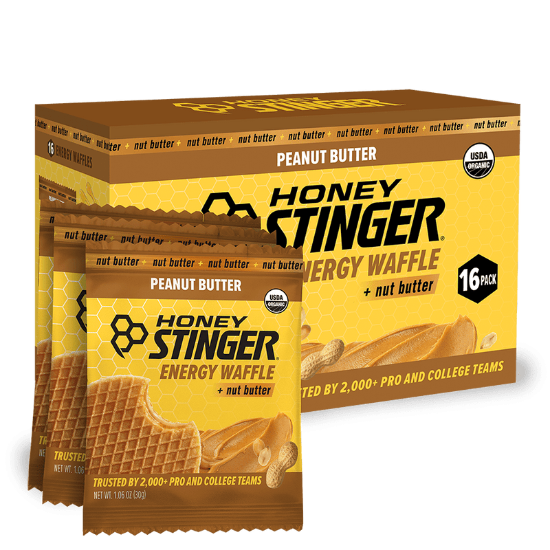 Honey Stinger Peanut Butter Energy Waffle packaging with a box of 16 packs on a white background